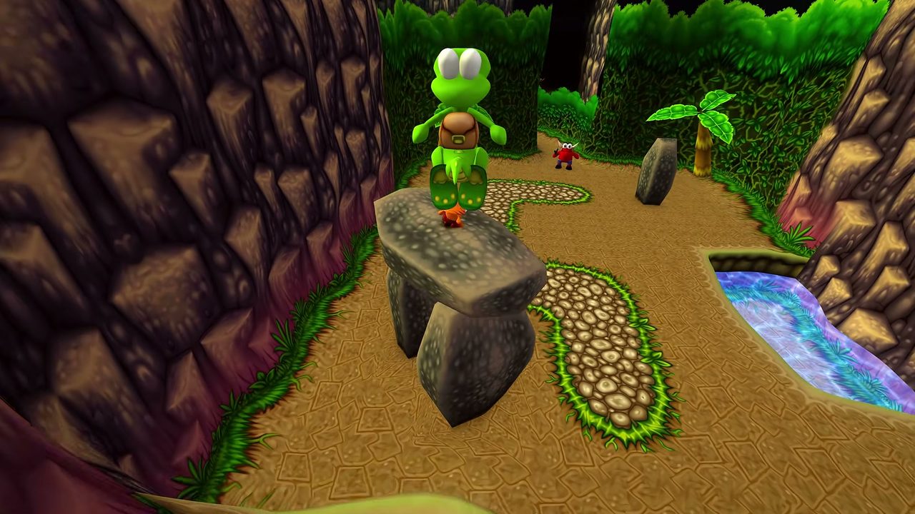 Croc stands on a rock platform on a green jungle path with foliage on both sides